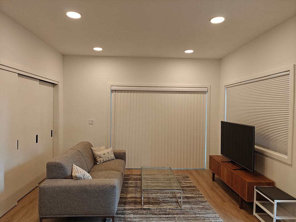 Another view of the living room. W&D and water heater is in the left closet. Large covered patio behind sliding doors.