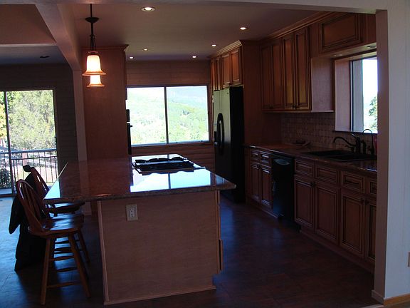 Kitchen area with large granite island with Jenn-Air range
