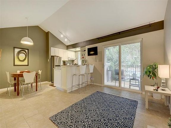 Open floor plan with lots of natural light and an exclusive view of the lush courtyard and recently resurfaced pool.