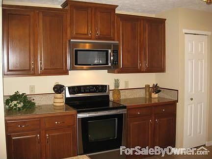 Kitchen : Aristokraft cabinets and granite tile countertops with stainless appliances