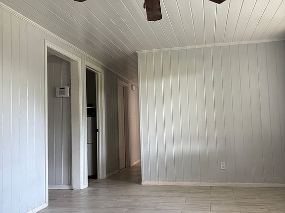 Nice large living space all tile. Freshly painted walls. With decorative hearth and decorative fireplace.