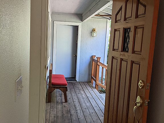 View out the front door. On opposite side of deck is door to the garage.