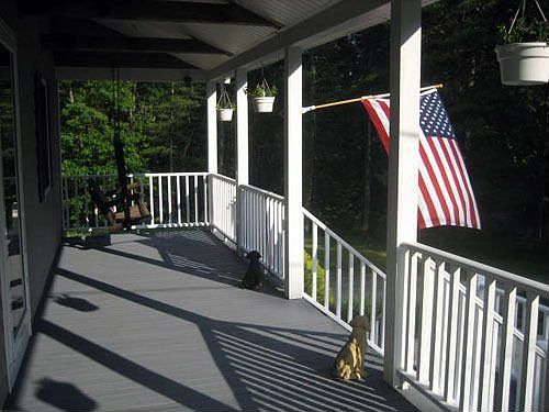 very spacious farmers porch extends entire width of house. w/attached swing