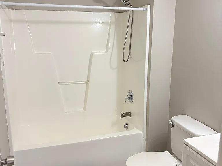 Full bathroom with tub/shower combo, updated vanity storage, and easy-care flooring for everyday convenience.