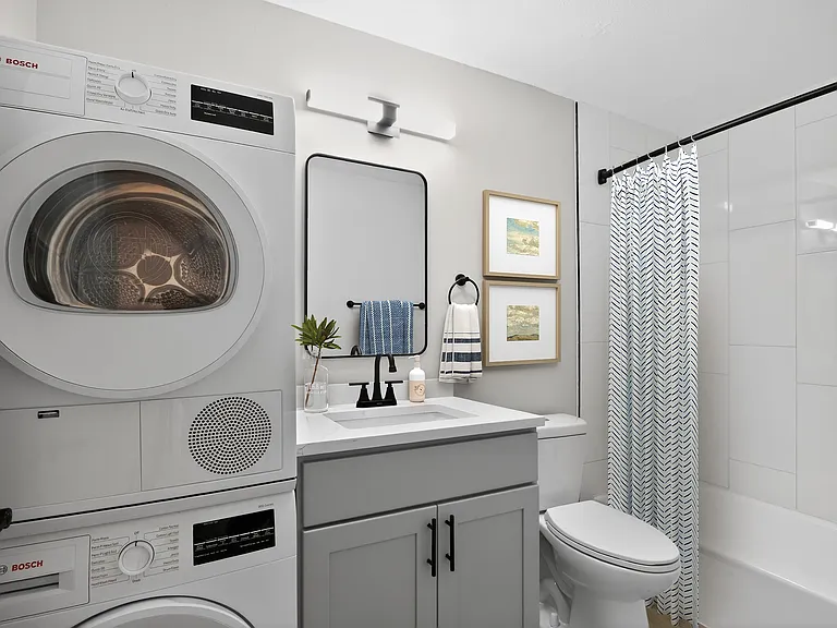 Elevate your lifestyle at Eagle Rock Apartments at West Hartford. This stylish bathroom features modern amenities, including in-unit laundry and sleek finishes for ultimate convenience. Don't miss outschedule your tour today!