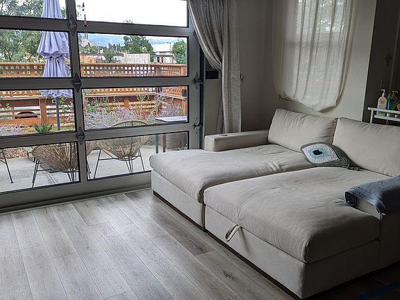 Roll-up garage door in the living room allows for amazing natural light, plus a relaxing breeze on good weather days (all the time in Denver!). It comes with an automatic screen so bugs can't get in.