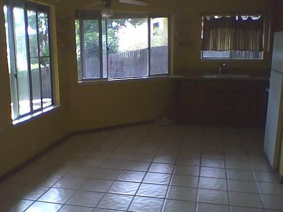 This is the living/kitchen space, facing the kitchent. Those icky curtains are gone and the cabinets are painted white now.
