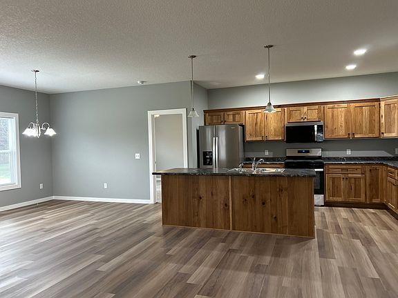 Kitchen view with stainless steel appliances: refrigerator, stove/oven, microwave, and dishwasher