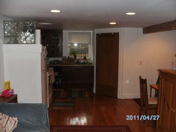 Kitchen with door to bathroom. New frig and electric stove.