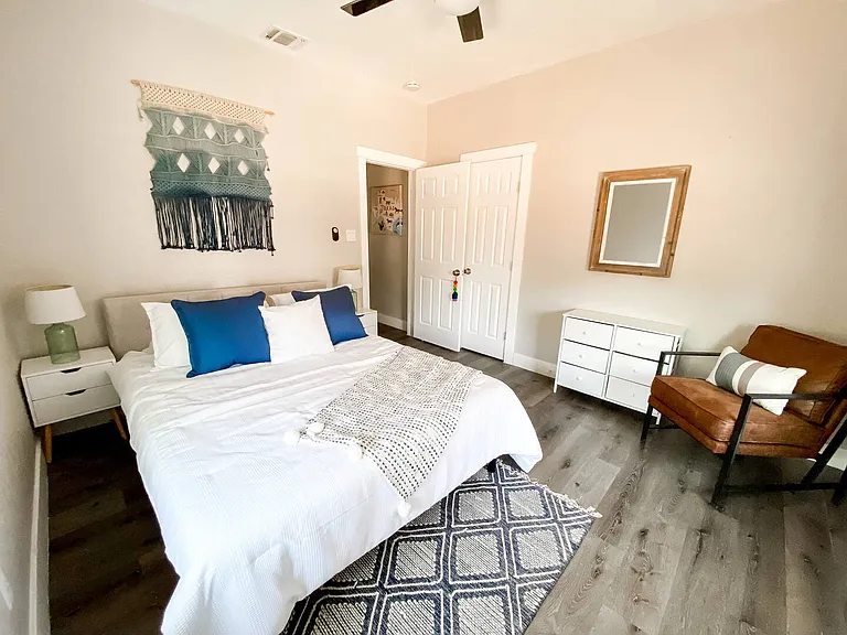 Bright and inviting primary bedroom featuring abundant natural light, a ceiling fan, closet space, and a comfortable layout designed for rest and relaxation.