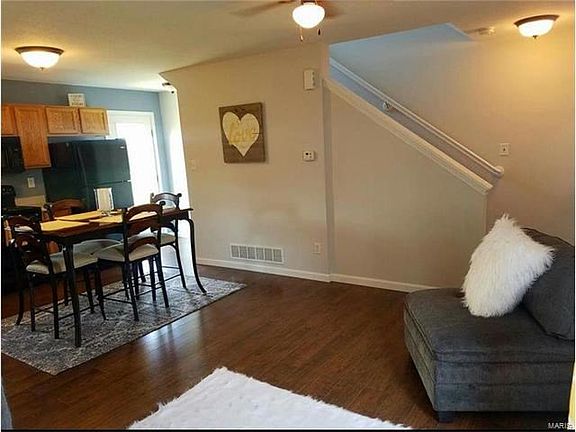 kitchen/living area with stairs leading up to 3 large bedrooms and loft