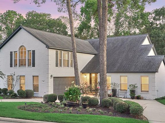 Lovely curb appeal with lush green landscaping and a circle driveway for additional parking space. Oversized garage features a built-in sink.