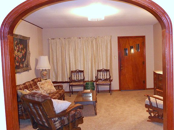 Wooden Arch frames entry from formal dining to formal living