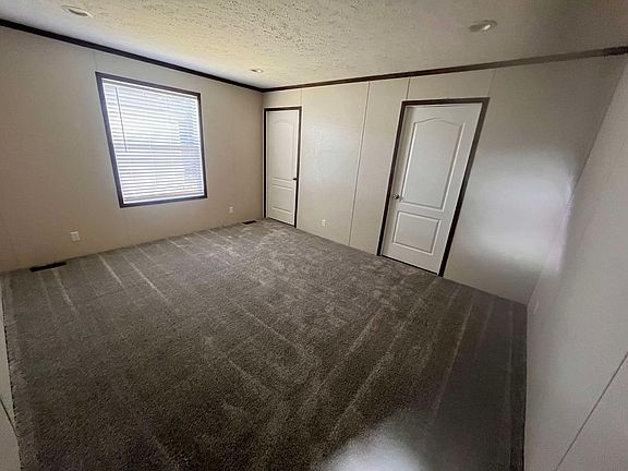 master bedroom also includes a walk in closet with a personal bathroom