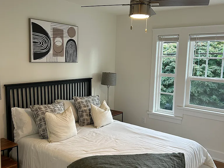 The bedroom can accommodate a king-sized bed with lots of light and a ceiling fan