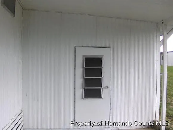 11 X 8 utility with washer and dryer hook ups adjoining 11 X 22 breezy car port.