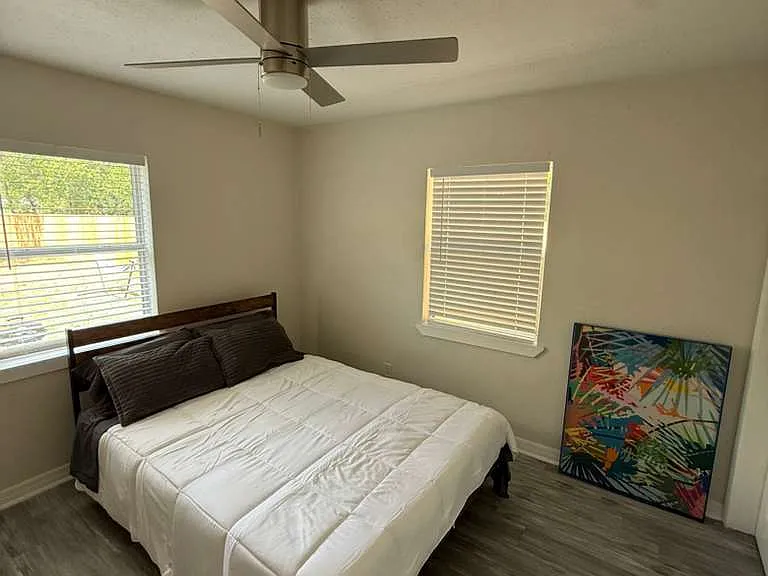 Stylishly furnished private bedroom with queen bed