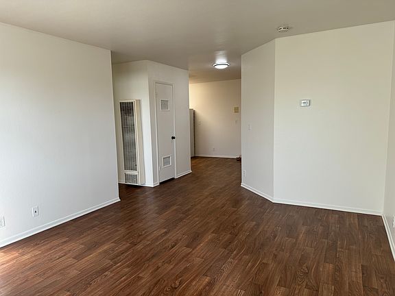 View from living room to front door & kitchen
