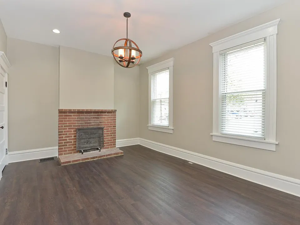 Living room with hardwood floors, gas fireplace.