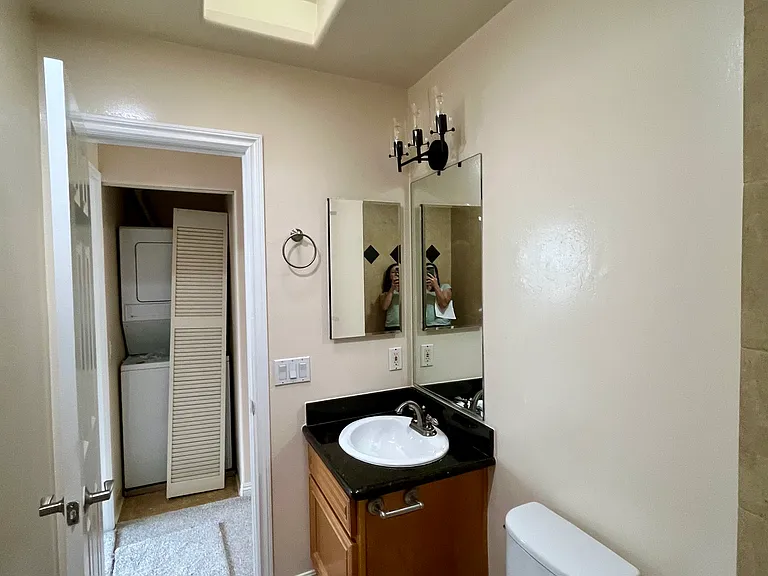 Updated bathroom vanity with storage, medicine cabinet, and modern light fixture