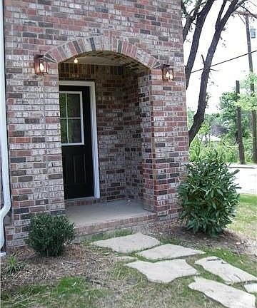 Arch detail of front entry on model. This home has custom quality/design.