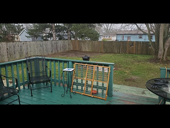 backyard with deck, 4 metal chairs and metal table