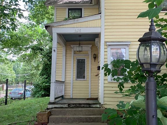 Front gate leads into fenced in yard. Front porch and main door
