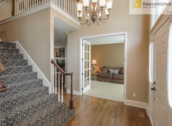 Front back stairway w/ designer carpet and stained and glazed ha