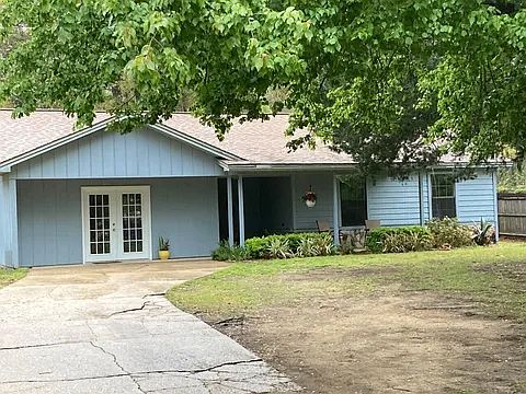 Front porch and covered entry with patio doors into game/utility room