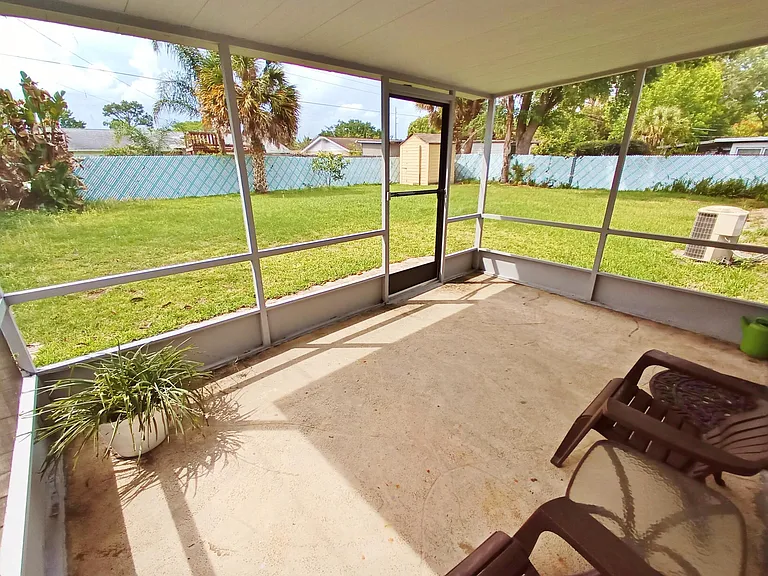 Screened-in porch with large fully fenced-in back yard