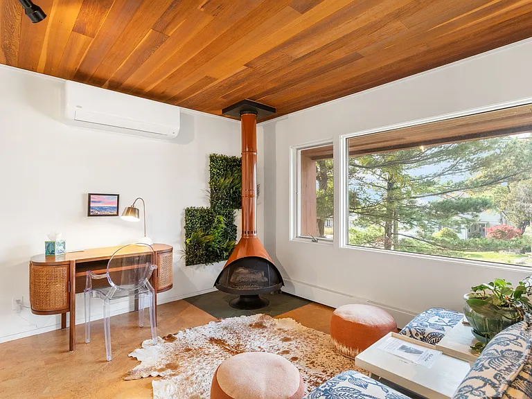 Second sitting area on main floor with fireplace and desk