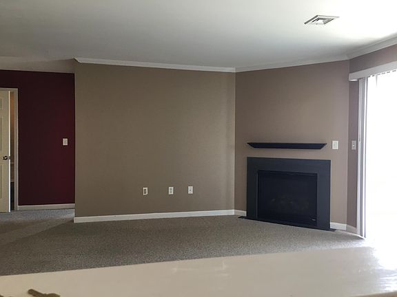 Large open family room with fireplace and slider to deck