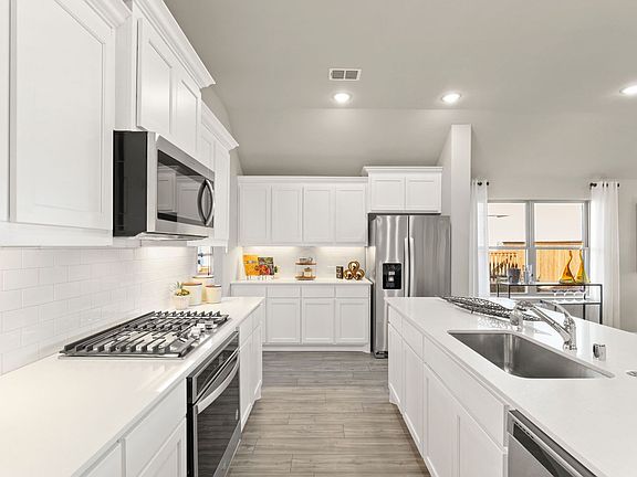 Kitchen in the Diamond home plan by Trophy Signature Homes - REPRESENTATIVE PHOTO