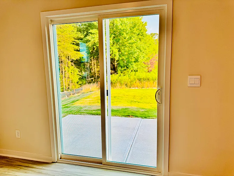 Step outside to the backyard via this sliding door.