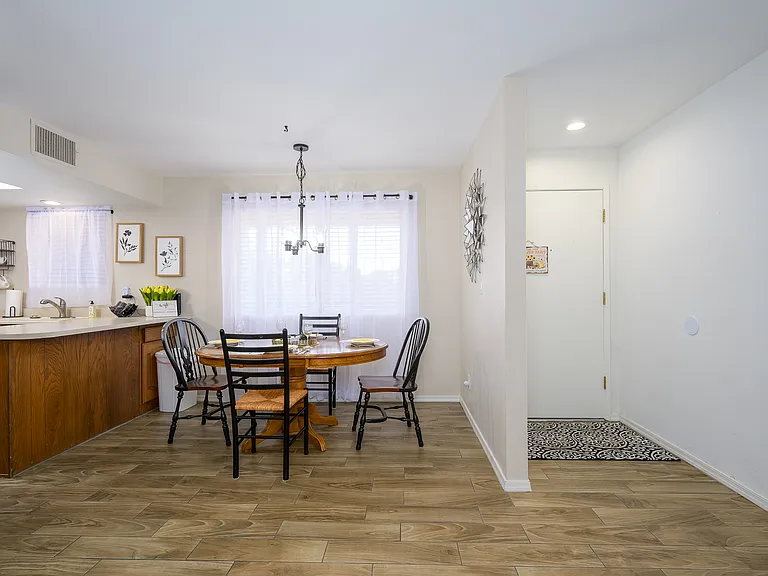 View of front door and dining area.