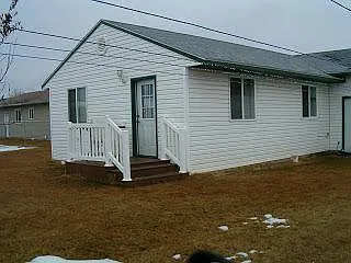 Fenced backyard with shed.