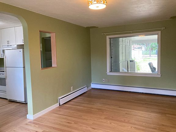Livingroom opens to the kitchen and has a large picture window looking out into the patio and spacious backyard. There is also alley access.