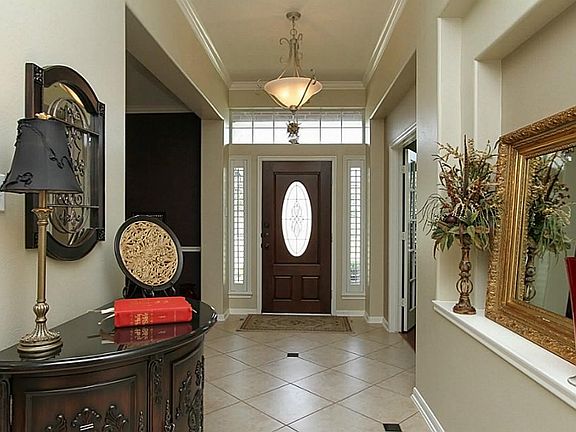 This home features a stained leaded glass front door with side lights, Plantation shutters, and a la