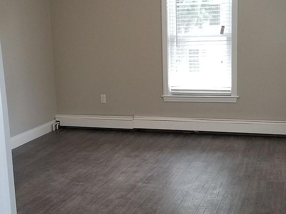 Living room with modern laminate flooring and ceiling fan
