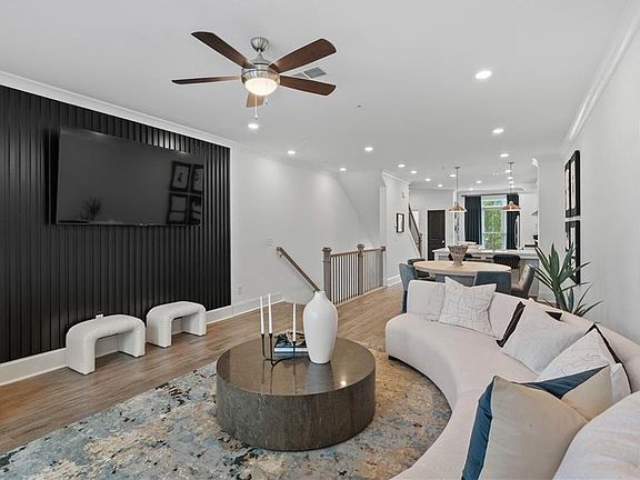 Living room featuring ornamental molding, light wood finished floors, recessed lighting, and ceiling