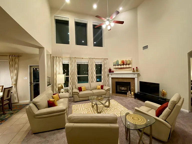 High ceiling family room with recessed lighting and fireplace