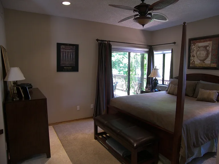 Master Bedroom with a door leading to a covered deck in backyard