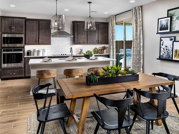 Dining and kitchen within the great room of the Dakota model home.