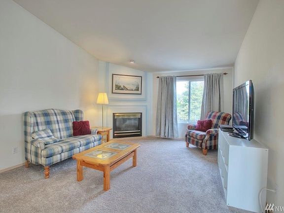 Spacious living room with cozy gas fireplace. 