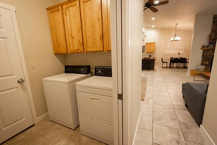 Laundry room depicted, door on left leads into garage, pocket door on right separates laundry room from hallway
