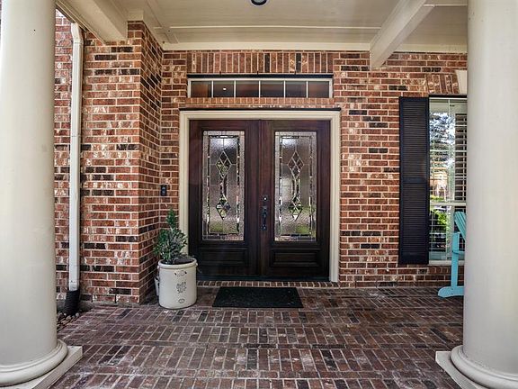 Beautiful double glass and wooden doors and brick elevation greet you at the front of the home with two majestic columns that frame the front entry.