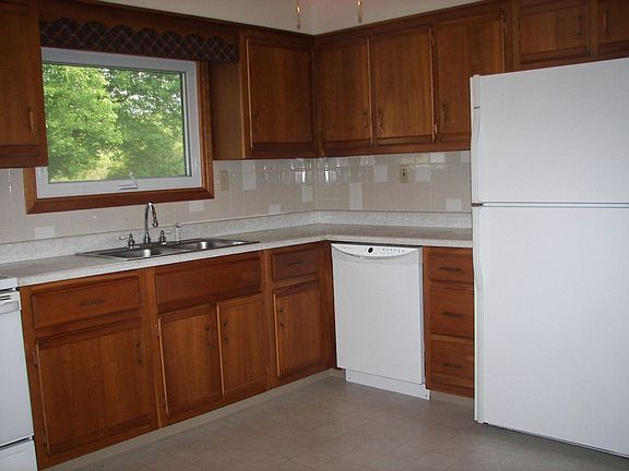 Kitchen overlooks private backyard.