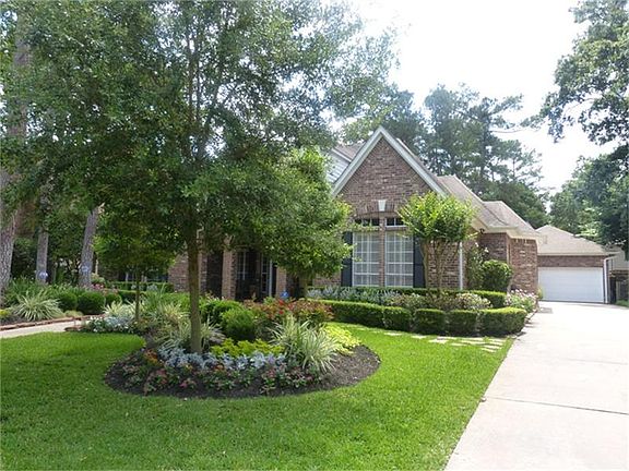 The private  detached 2 car garage  with a walkway leads through  an iron  gate to a backyard underground sprinkler system with drip irrigation and french drains in the gardens and patios.