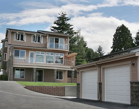 View of house from street below. Garage has shop and a view!
