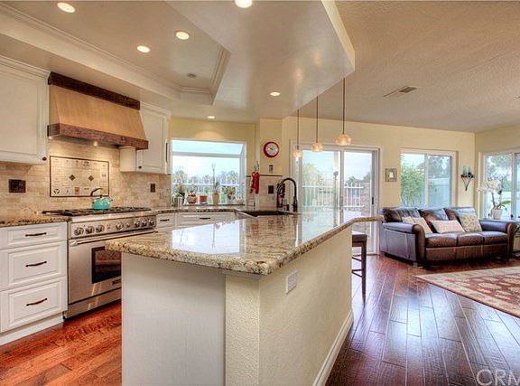 Sleek and stylish kitchen that flows through the living room